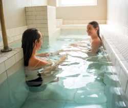 Medium shot of two women relaxing in the spa at Berkeley Springs State Park.