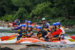 A medium shot of rafters using a raft from Adventures on the Gorge during the summer.