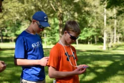 Young explorers venturing toward one of the cache sites hidden within North Bend State Park.