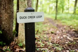 Sign marking the Duck Creek Loop, suitable for biking in Watters Smith Memorial State Park.
