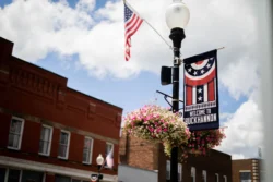 Cropped shot of Buckhannon Street with Welcome to Buckhannon signs and American flags on lamppost