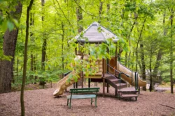 Wide shot of the vacant playground for children captured during the summertime.