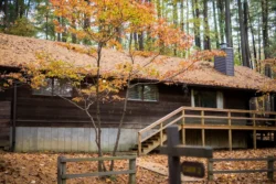 One of North Bend State Park's cozy vacation cabins captured in autumn among vast fall foliage.