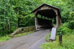 Angled shot of Herns Mill Covered Bridge in Historic Lewisburg during the summer.