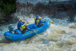 Wide shot of whitewater rafters on the Gauley River during the summer or spring.