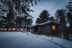 Cozy cabin in Pipestem Resort State Park on a winter evening.
