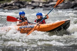 Two people on a raft with Adventures On The Gorge during the summer.