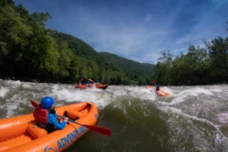 Whitewater rafters rafting in the river during the summer.