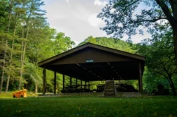 Crum-Morgan picnic shelter during the summer with children's playground equipment.