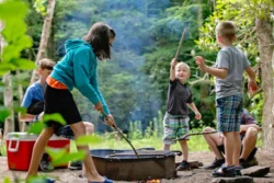 Family roasting marshmallows while camping