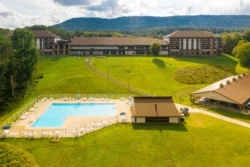 Aerial view of the pool and pavilion area behind the lodge at Canaan Valley Resort State Park during the summer.