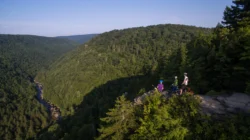 Aerial shot of mountain bikers taking in the view from a scenic lookout at Blackwater Falls State Park.
