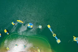 Drone overhead shot of some water-based inflatables on Tygart Adventure Lake in the summertime.