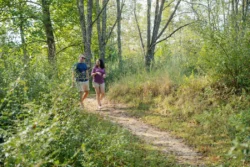 A couple hiking on a trail at Stonewall Resort State Park