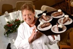 Server carrying a tray full of desserts