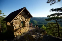 Angled view of friends enjoying a sunset view atop Cranny Crow overlook.