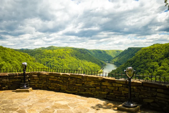 Scenic overlook with tower viewers overlooking the river and surrounding forest during the summer.