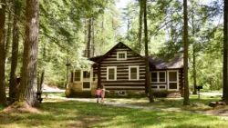 Two girls walking the gravel path of a cozy cabin in Greenbrier State Forest during the summer.