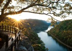 The evening sun peeks over the mountains at Hawks Nest State Park