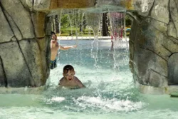 Two boys splashing around the wading pool in Greenbrier State Forest during the summer.