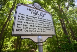 Low-level shot of archive sign for the Henry Clay Furnace in Coopers Rock State Forest during the summer.