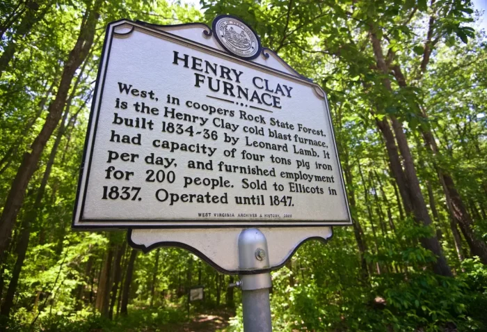 Low-level shot of archive sign for the Henry Clay Furnace in Coopers Rock State Forest during the summer.