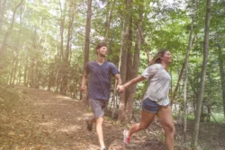 Couple running along a trail at Bluestone State Park