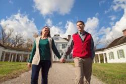 Close-up shot of couple walking in front of the mansion at Blennerhassett Island Historical State Park during the summer.