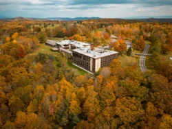 Aerial view of McKeever Lodge surrounded by gorgeous fall foliage in Pipestem Resort State Park.