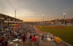 High-level view of the GoMart Ballpark during a summer night baseball game.