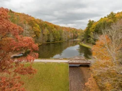 Overhead view of a bridge crossing Seneca Lake to a paddleboat dock during the fall.