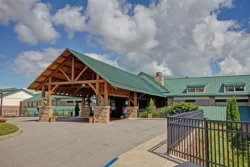 A summer afternoon in front of the Stonewall Resort State Park lodge entrance.