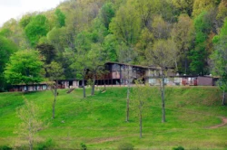 Wide shot of Tygart Lake State Park lodge exterior during the summer.