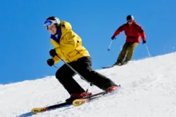 Angled view of two skiers having some fun on the slopes at Winterplace Ski Resort.