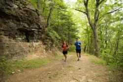 Two runners going for a run through Pipestem State Park