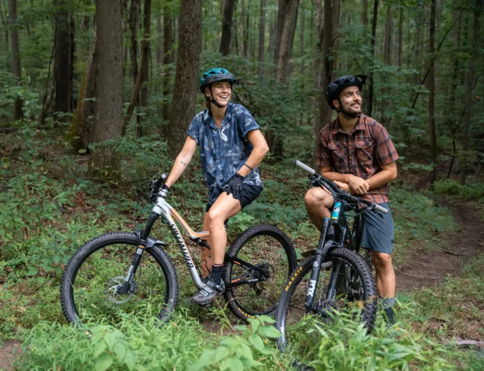 A couple exploring bike trails in the forest