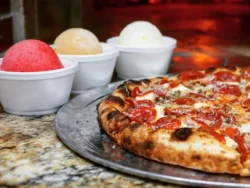 A delicious pizza and three scoops of ice cream