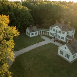 An aerial shot of the Blennerhassett mansion and surrounding grounds as the sun sets in the background