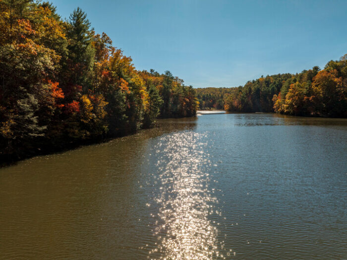 The sun reflects off of Pipestem Lake on a beautiful autumn day