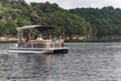 A pontoon boat filled with people enjoying a day on Summersville Lake