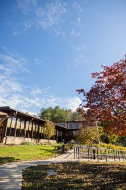 Accessible walkway leading to park building amid fall foliage at North Bend State Park