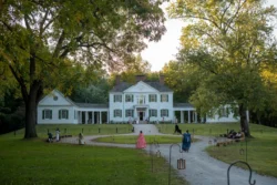 White historic mansion with visitors on lawn at Blennerhassett Island Historical State Park