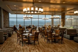 Dining room at Pipestem Resort State Park with large windows overlooking mountain views and seated guests
