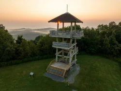 Observation tower at Pipestem Resort State Park overlooking misty mountain valleys at sunrise